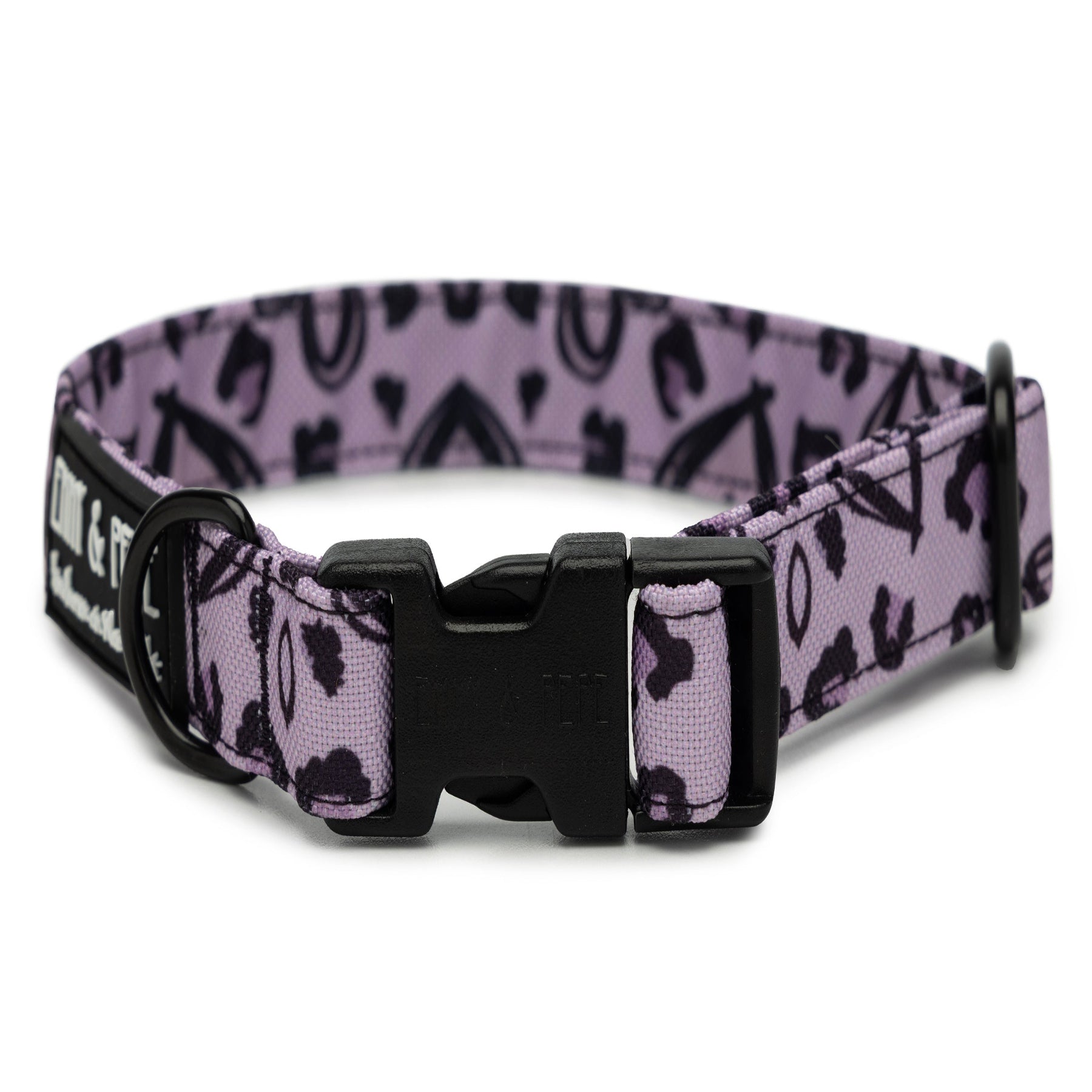Lilafarbenes mit Herzen versehenes Hundehalsband. Das Halsband verfügt über eine robuste, schwarze Steckschnalle mit „EMMY & PEPE“-Gravur sowie schwarzem Metallring. Freigestellte Produktaufnahme auf weißem Hintergrund.