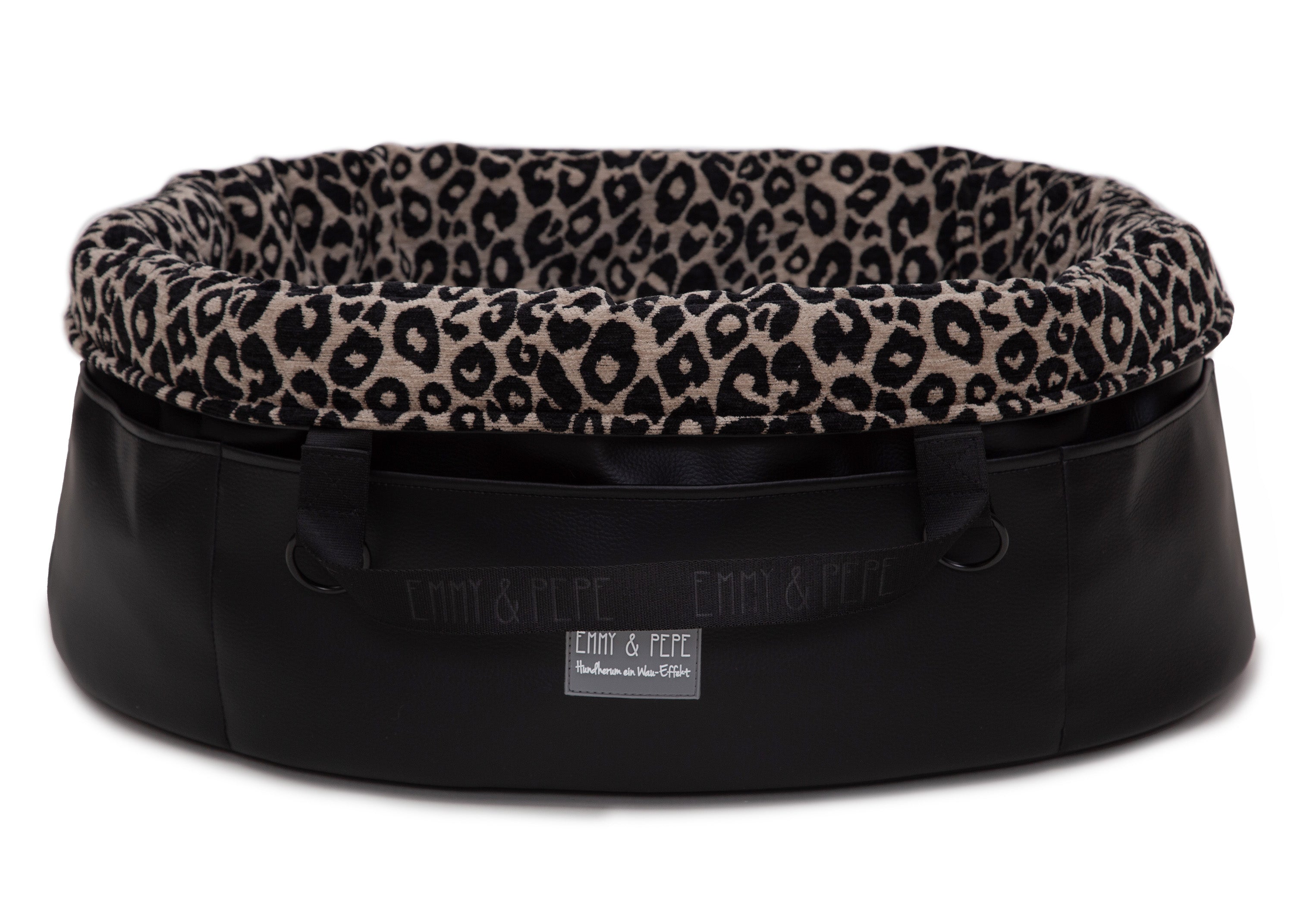 Wau-Snuggle Reisebett mit robustem schwarzen Kunstleder an der Außenseite und einem weichen, beigen Innenfutter mit schwarzem Leopardenmuster in oval - Rand umgeklappt