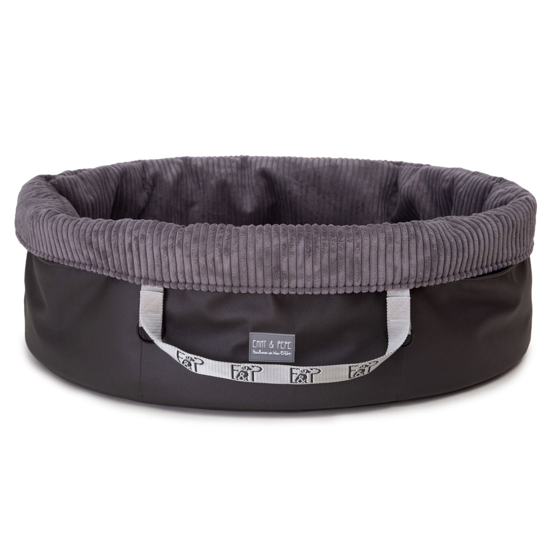 Freigestelltes ovales Wau-Snuggle Cord Dark Grey Hundekörbchen für unterwegs von EMMY & PEPE mit hohem Rand und dunkelgrauem Cordstoff innen.