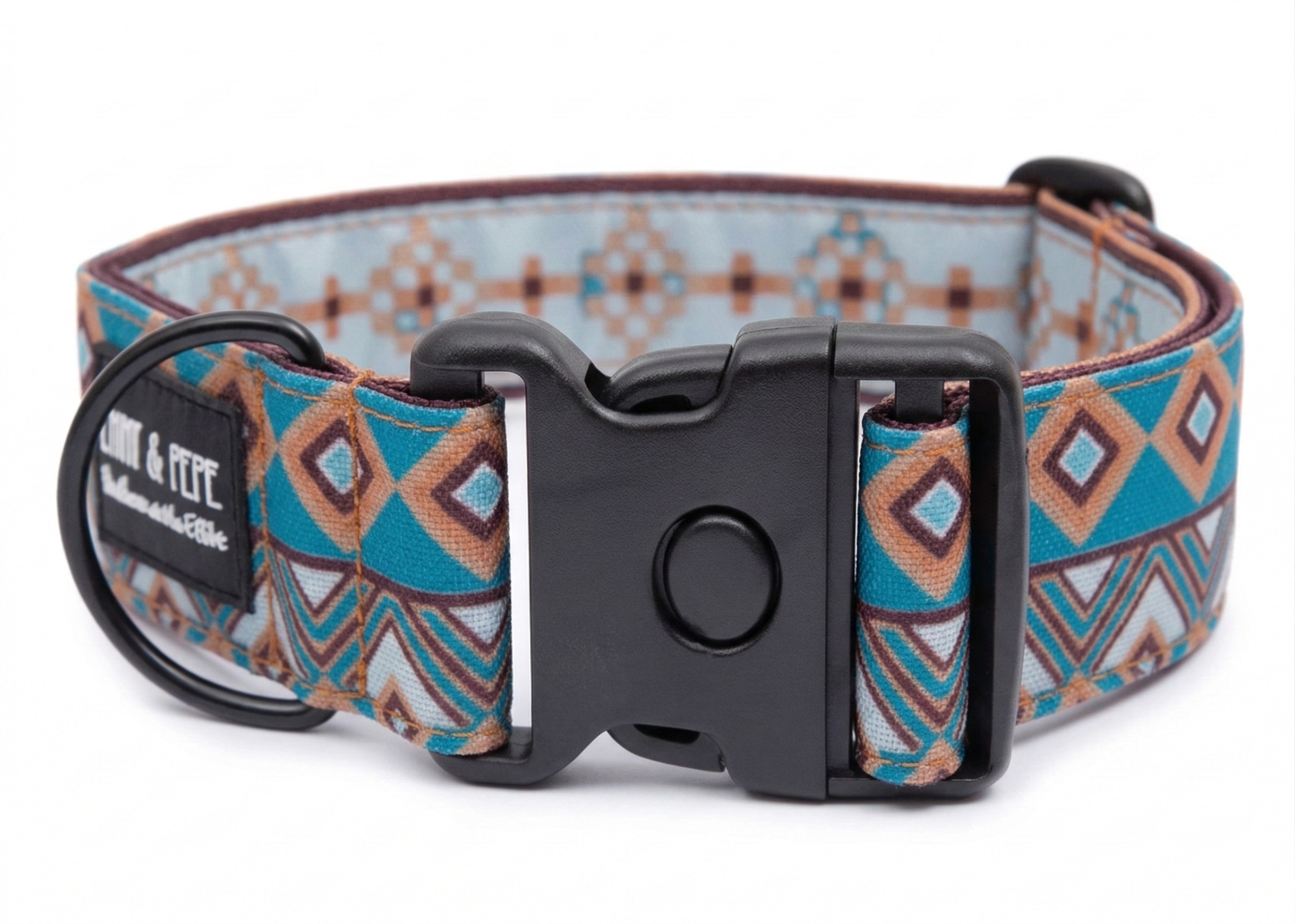 Buntes Hundehalsband in Bohomuster aus Stoff mit schwarzem Kunststoff-Schnellverschluss und schwarzem Metallring zur Befestigung einer Leine. Das Halsband ist vor weißem Hintergrund fotografiert und zeigt eine breite, verstellbare Ausführung mit gepolsterter Innenseite. Auf einem kleinen Etikett am Ring ist ein Markenlogo zu erkennen.